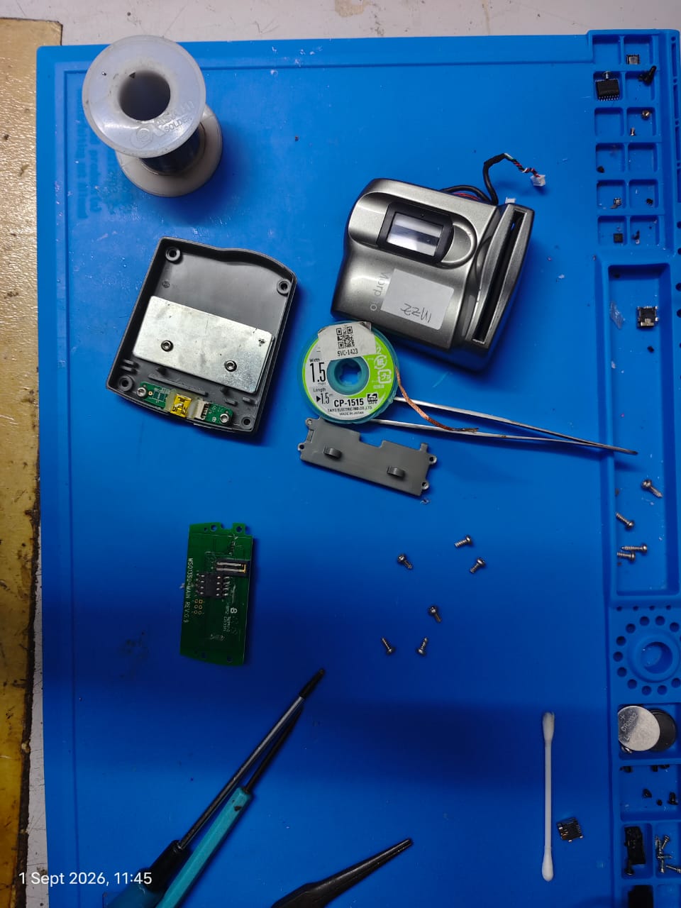 Fingerprint reader parts on a repair bench